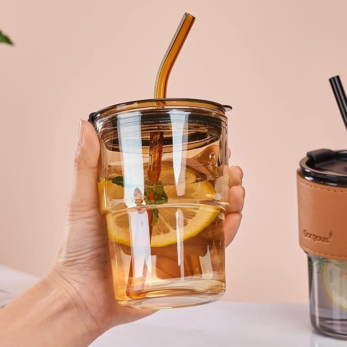 Reusable glass tumbler with a lid and straw